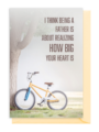 A child hugs a man on a bicycle with a touching fatherhood quote.